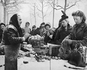 Liberation Prints: Parisians purchasing apples from a street vendor in the snow 1945