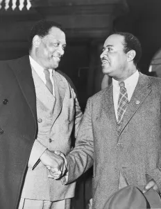 Robeson Prints: Paul Robeson (1898-1976), shaking hands with New York City Councilman Ben Davis (1903-1964)