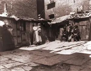 Housing Prints: Paved yard lines with outdoor latrines in one of the city's worst slums on Jersey Street