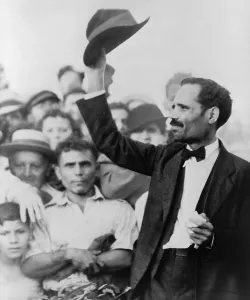 Pedro Albizu Campos (1893-1965), Puerto Rican nationalist, raising his hat to a crowd as he is arrested following the deadly shooting of a policeman by two nationalists