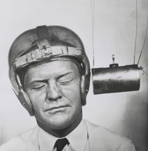 Testing Prints: Pendulum pounding a plastic helmet worn for testing to improve headgear for football players