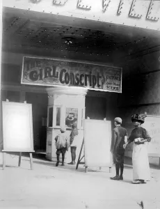 Ticket Booth Prints: People in front of a movie theater showing THE GIRL CONSCRIPT
