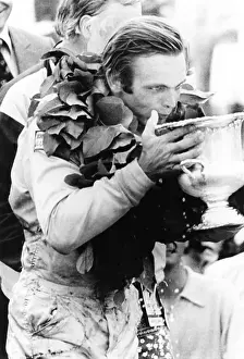 Winner Prints: Peter Revson drinks from his trophy after winning the Canadian-American championship