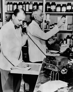 Pharmacist Prints: A pharmacist demonstrates the use of an early phone answering machine