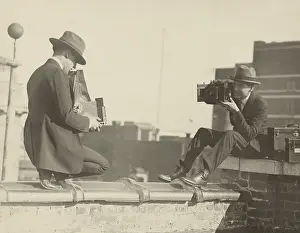 News Prints: Photographers taking each other's picture with while perched on a Washington