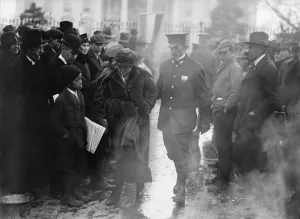Social Movements Prints: Policeman leads an arrested National Woman's Party protestor away from a woman's suffrage bonfire demonstration