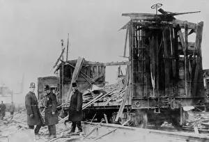 Espionage Prints: Two policemen and a civilian survey the ruins along the Lehigh Valley Railroad tracks where boxcars were riddled by