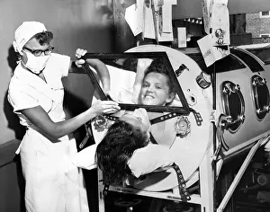 Medicine Prints: Polio patient Flossie Rogers looking at the world through the mirror of her iron lung in June 1957