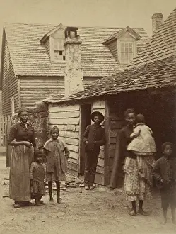 Informal Prints: Portrait of an African American family standing in front of a house