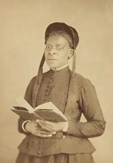 Skirt Prints: Portrait of an African American woman, wearing glasses, and posed with book, c. 1880-1900