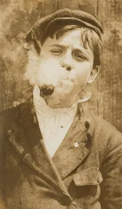Images Dated 8th July 2008: Portrait of a boy smoking a pipe