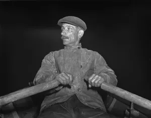 Fishermen Prints: Portuguese dory fisherman rowing out to his boat at 4 30 in the morning for the fishing banks off Cape Cod