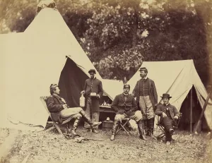 Servants Prints: Posing for the camera, a White officer faces his young Black servant