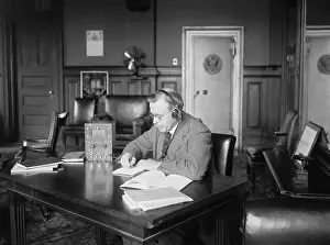 Hubert Prints: Postmaster General Hubert Work listening to a radio in his office, March 9, 1922