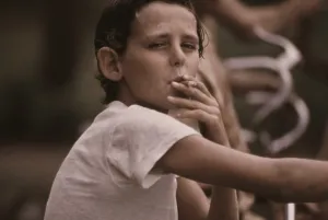 City Life Prints: A pre-teen boy smoking a cigarette on Kansas City's west side. Ca. 1973-75
