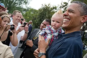 Expression Prints: President Barack Obama holds a baby during an White House Independence Day celebration
