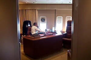 President Barack Obama holds a conference call with advisors from his office aboard Air Force One. July 24, 2012, during a flight to Portland, Oregon (BSLOC_2015_13_137)
