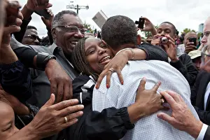 Obama Prints: President Barack Obama is hugged by a woman during a Labor Day celebration