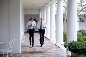 President Prints: President Barack Obama and Vice President Joe Biden run through the West Wing Colonnade of the White House