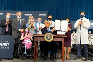 Conservative Politics Prints: President Donald Trump displays a symbolic executive order on a range of health care issues
