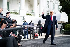 Epidemic Prints: President Donald Trump gives a clenched salute to the press and photographers