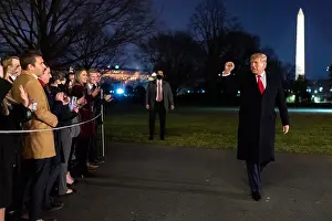 Salute Prints: President Donald Trump gives a closed fist salute to supporter at the White House on Jan