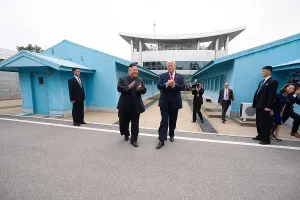 Diplomacy Prints: President Donald Trump and Kim Jong Un applaud as they take their first steps together in North Korea