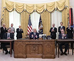 Clapping Prints: President Donald Trump leads applause after signing of a US-brokered