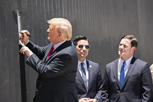 Autograph Prints: President Donald Trump signs a plaque commemorating the 200th mile of new border wall along the US-Mexico border near