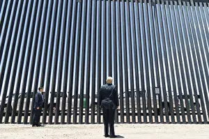 Barrier Prints: President Donald Trump stands before a section at the 200th mile of new border wall on the US-Mexico border near Yuma