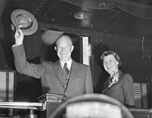 Corsage Prints: President Eisenhower and wife Mamie wave from the back of a train