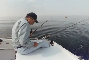 Relaxing Prints: President George H.W. Bush reading a long memo as he fishes at his summer home in Kennebunkport Maine