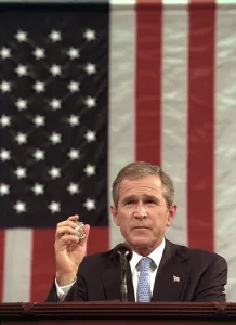Speeches Prints: President George W. Bush holds the badge of a Port Authority Police officer killed on Sept