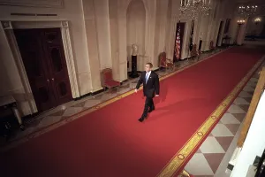 George W Prints: President George W. Bush walks to the East Room for a prime-time news conference