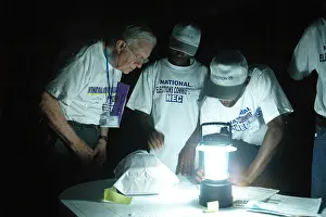 Records Prints: Former President Jimmy Carter observes poll closing by lantern-light in Monrovia during Liberias 2005 national
