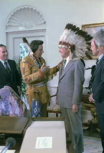 James Earl Prints: President Jimmy Carter wearing a feathered headdress presented to him by Iron Eyes Cody 1904-1999 an actor