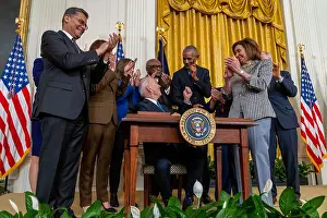 Obama Prints: President Joe Biden hands a commemorative pen to former President Barack Obama after signing his second executive order