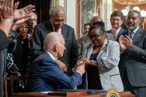 Applauding Prints: President Joe Biden, presents a souvenir signing pen to special guest, Viola Fletcher