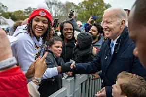 Adults Prints: President Joe Biden shakes hands with a multiracial group of guests attending the White House Easter Egg Roll