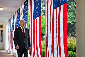 Garden Prints: President Joe Biden walks along the flag lines West Colonnade of the White House