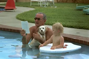 Swimming Pool Prints: President Lyndon Johnson celebrates his 60th birthday in swimming pool with dog Yuki and grandson Patrick Nugent