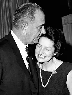 Married Couples Prints: President Lyndon Johnson kisses his wife Lady Bird as they greet guests at the White House
