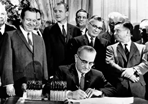 Legislation Prints: President Lyndon Johnson signs a $11