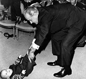 Grandson Prints: President Lyndon Johnson tugs the legs of his baby grandson, Lyndon Patrick Nugent