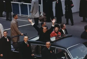 Inauguration Prints: President and Pat Nixon waving to the crowd from the Presidential limousine in the Inaugural motorcade