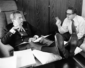 Kissinger Prints: President Richard Nixon and Henry Kissinger talking on Air Force One