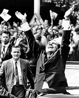 Joyous Prints: President Richard Nixon jubilantly acknowledges the cheers of apartment house dwellers as his motorcade proceeds
