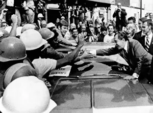 Supporters Prints: President Richard Nixon leans across car to shake hands with construction workers were from the new IBM building