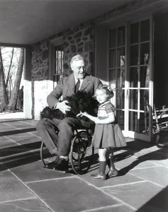Handicapped Prints: President Roosevelt in his wheelchair on the porch at Top Cottage in Hyde Park NY with Ruthie Bie and Fala