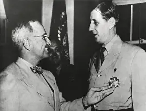 Degaulle Prints: President Truman admires the Legion of Merit Degree Medal he has just awarded Charles De Gaulle